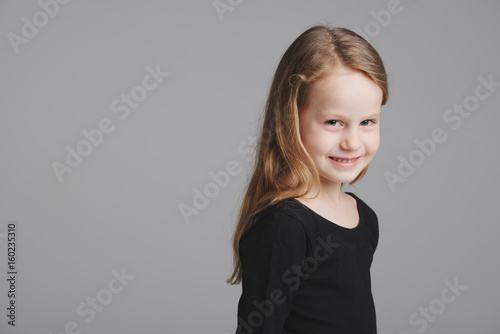 little girl studio portrait on grey background