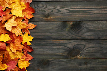Wooden background with autumn leaves