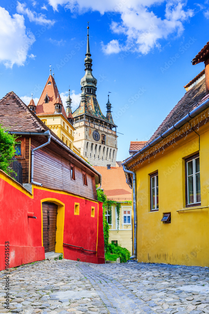 Sighisoara, Romania. Medieval street with Clock Tower in Transylvania.