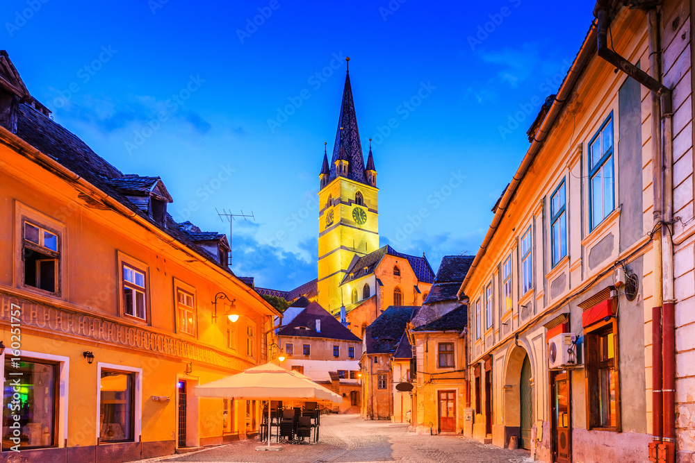 Naklejka premium Sibiu, Romania, Lutheran cathedral tower in the Small Square (Piata Mica).