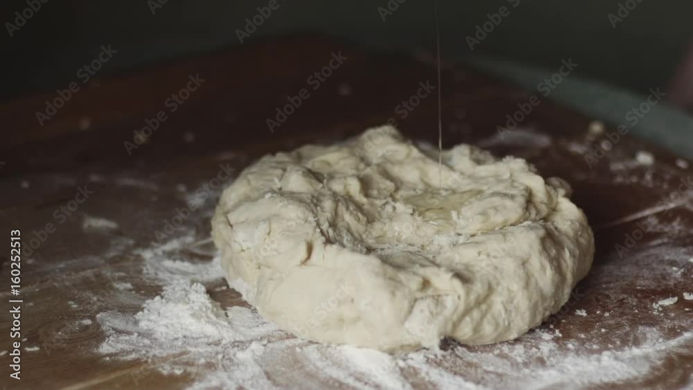 Senior woman hands knead dough on a table in her home kitchen. Slow motion Senior woman hands knead dough on a table in her home kitchen. Slow motion