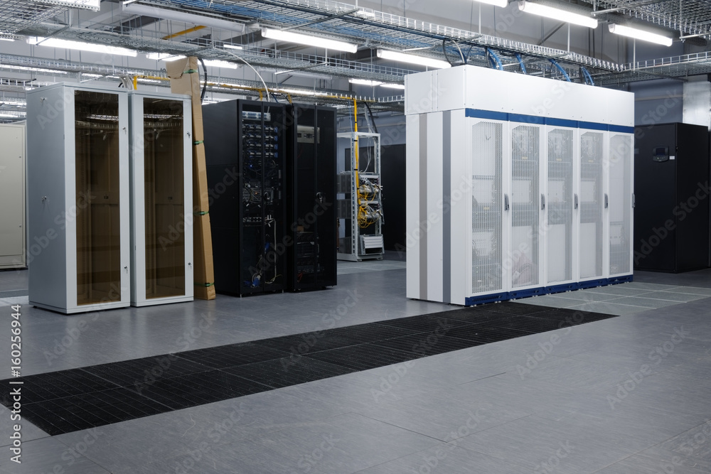Telecommunication equipment with many cables, switches and air conditioners in a modern communications center
