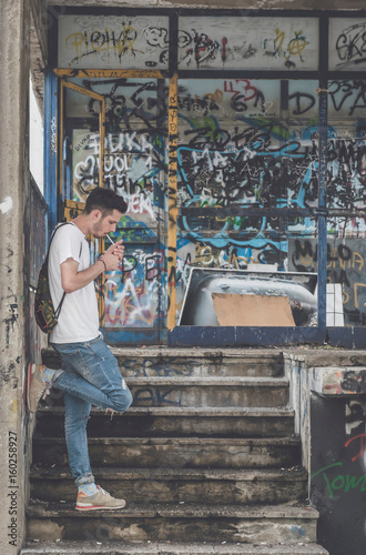 Hipster posing and lighting his cigarette,selective focus photo