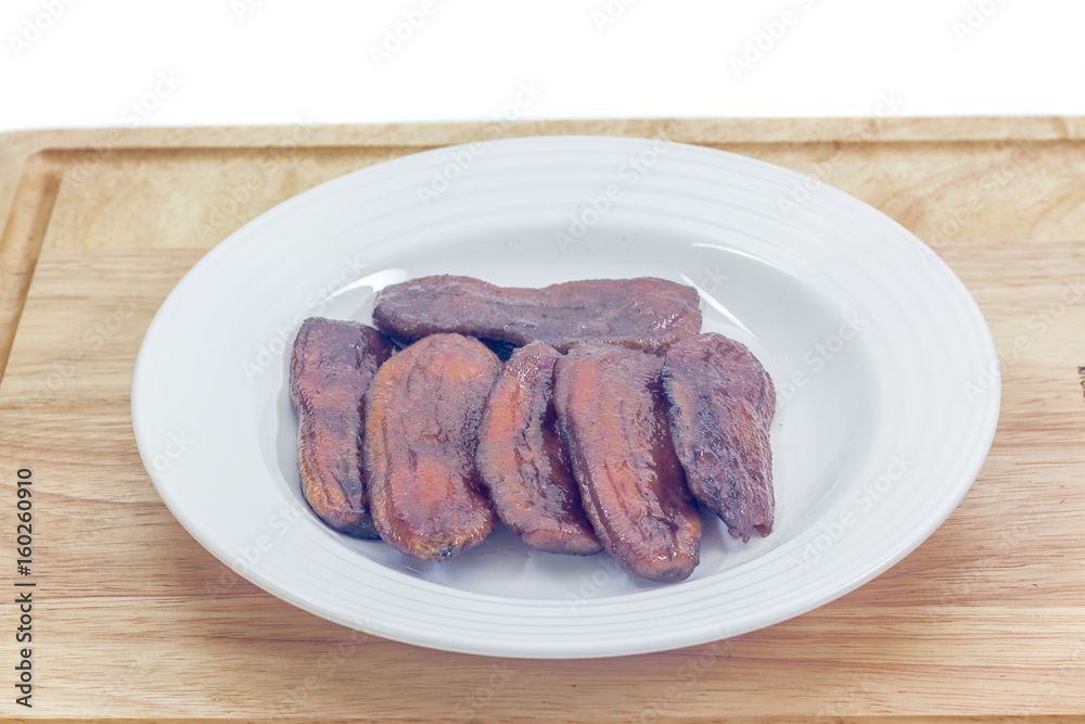 Preserve banana in dish on wooden Preserve banana in dish on wooden