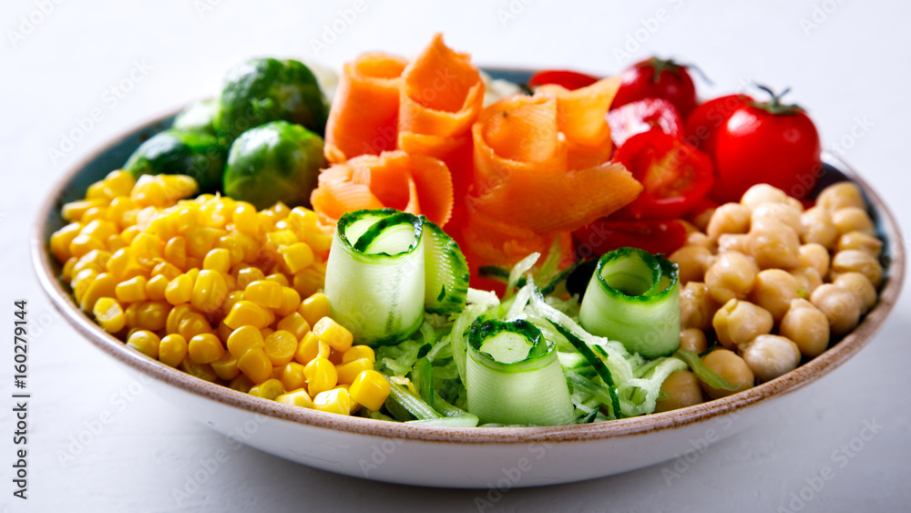  Buddha Bowl Vegetarian on a white Background. Raw Vegetables and  in chickpeas  a one bowl.Food or Healthy Diet concept.Super Food.Copy space for Text. selective focus.