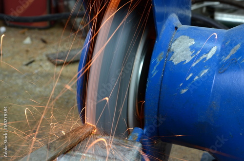 grinding machine with sparks flying, closeup