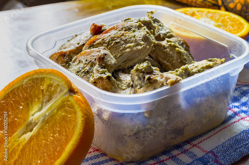 Boiled chicken breast with dill in kefir with orange on the table. Ducan s diet