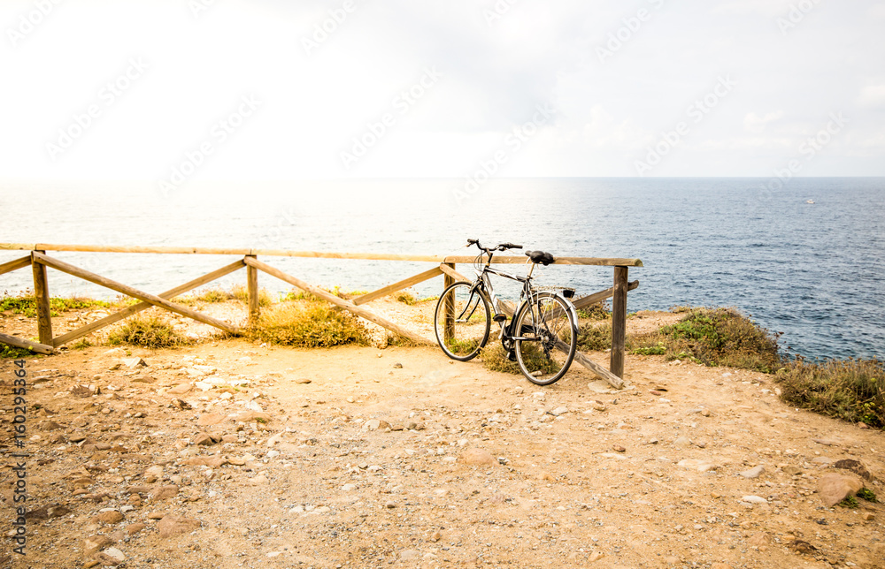 Blurred image. Bicycle parked on the beach with sunny day in tone vintage style.