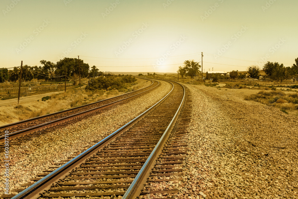 Vintage Railroad Tracks on Curve Path into the Sun