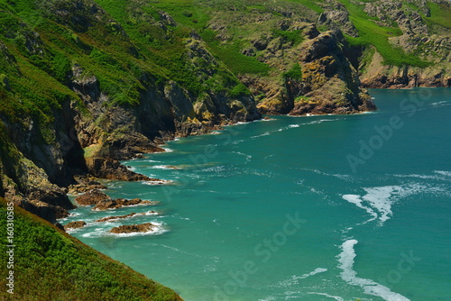 Plemont Bay, Jersey, U.K. Telephoto image of an idyllic bay in the Summer at high tide.