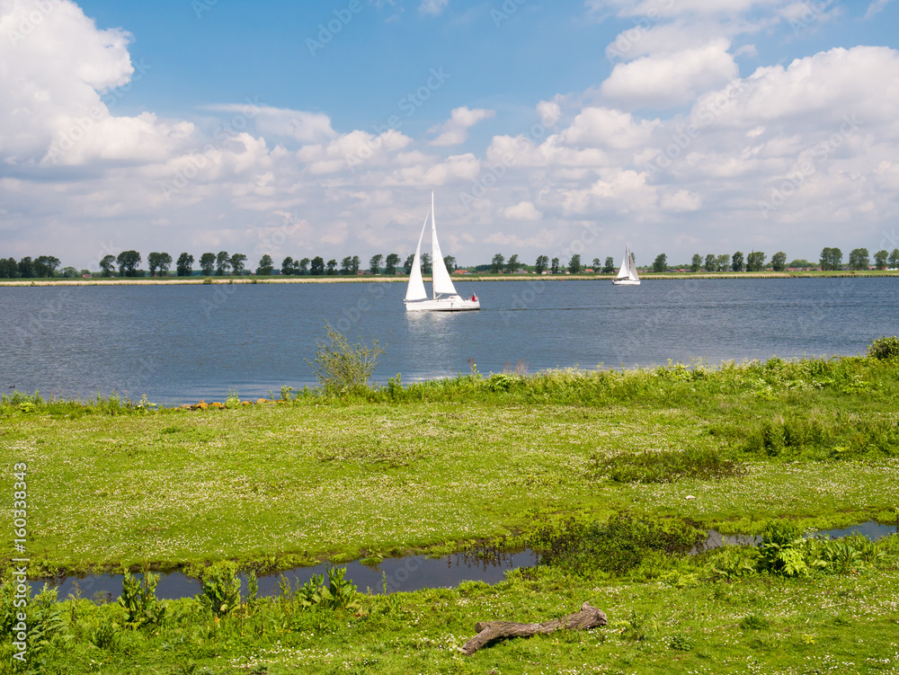 Sailboats on Haringvliet estuary and Tiengemeten island, Netherlands Sailboats on Haringvliet estuary and Tiengemeten island, Netherlands