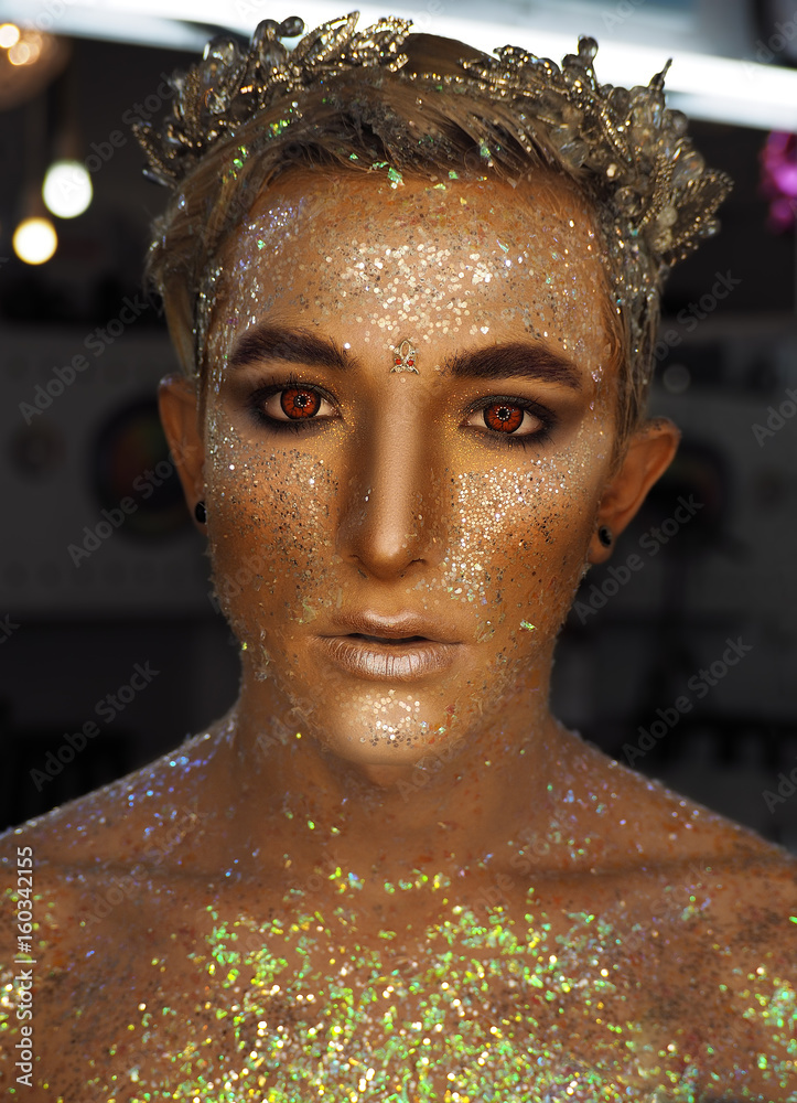 Fototapeta Young boy at the art make-up as golden caesar with red eyes