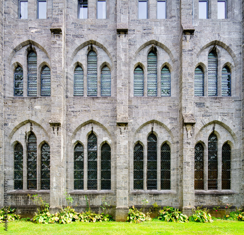 Full frame shot of old stone building facade with windows, Belgium.