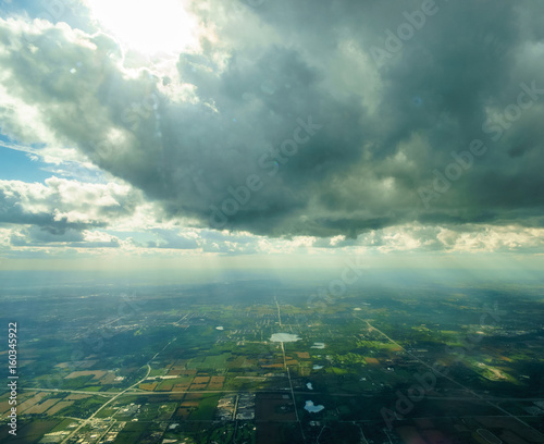 Aerial view of clouds high in the sky and landscape below, over Belgium.
