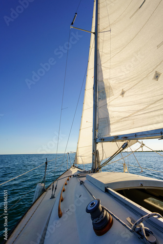 Sailboat at sea with view of horizon, Toronto, Ontario, Canada.