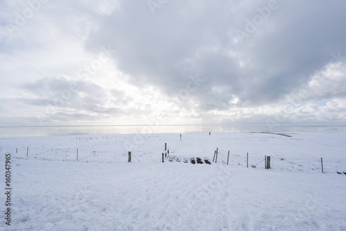 Deep snow covered landscape with fencing and sky, Iceland, Europe.