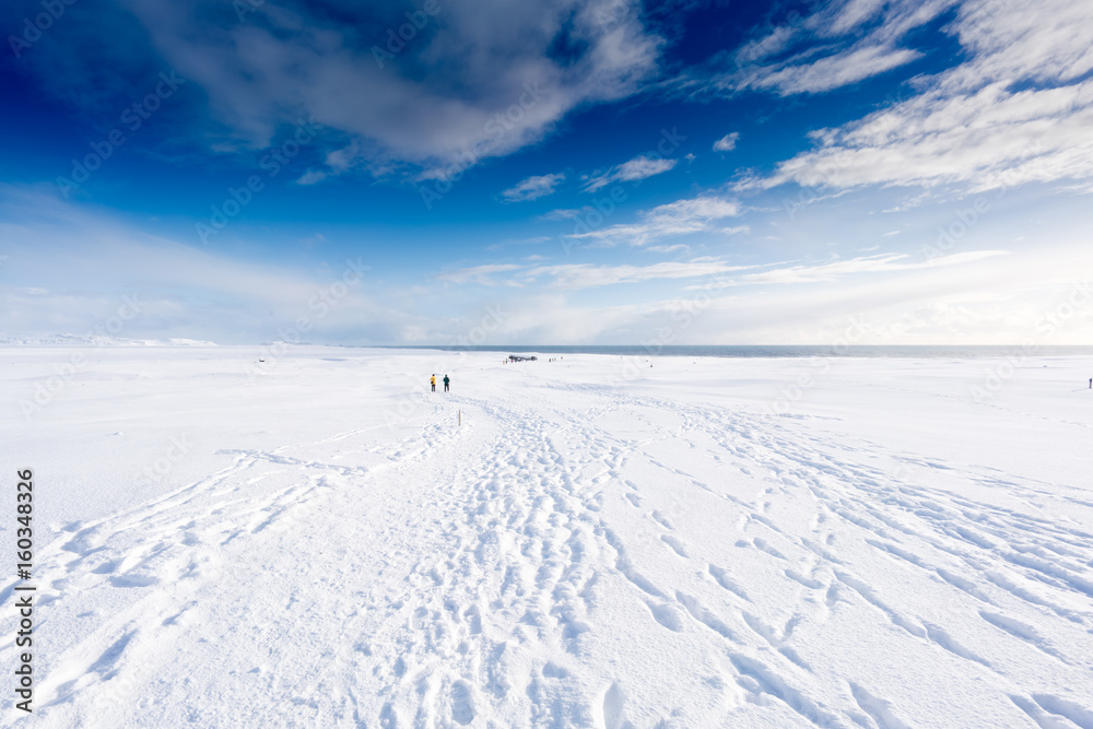 Deep snow covered landscape, tracks and blue sky, Iceland, Europe.
