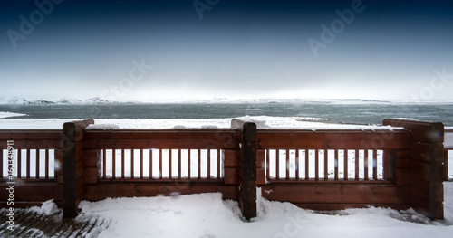 Wooden fence in deep snow covered landscape  by day  Iceland  Europe.