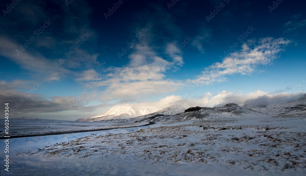 Deep snow covered mountain, landscape and blue sky, Iceland, Europe.