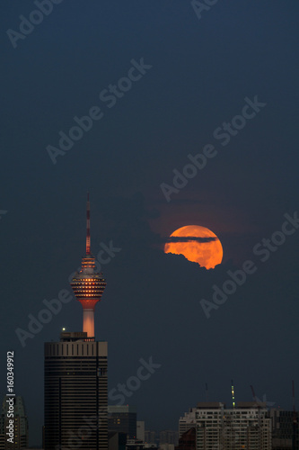 Photography Moon set over downtown Kuala Lumpur
