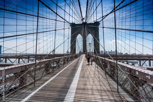 View along Brooklyn bridge with pedestrians walking, New York, USA. © bruno135_406