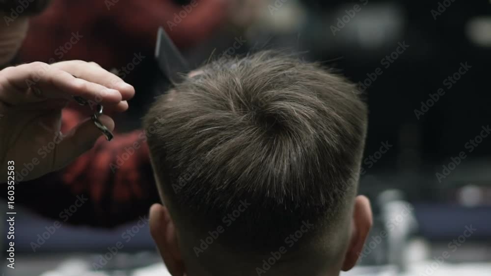 Barber Cuts the Hair in the Barbershop. Slow Motion Barber Cuts the Hair in the Barbershop. Slow Motion
