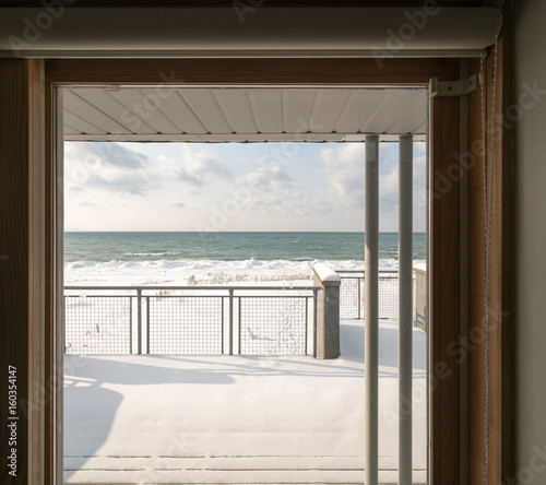 Looking through window out to sea on sunny day  summer.