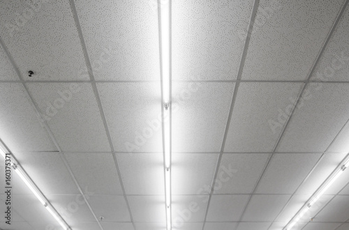 Warm white fluorescent or neon light on ceiling