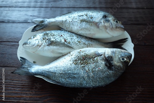 Lots of fresh fish on the plate for cooking photo