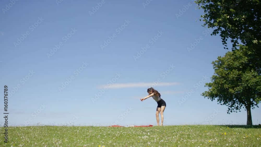 Young female outdoors practices her yoga, with plenty of space for text Young female outdoors practices her yoga, with plenty of space for text