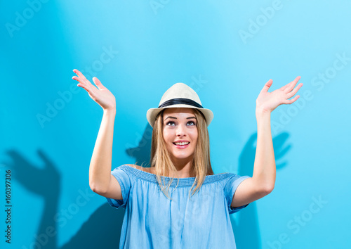 Young woman reaching and looking upwards