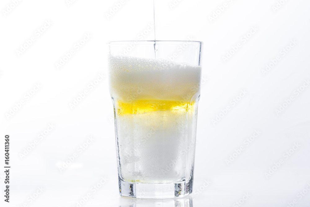 Pouring beer into Glass on White background, clipping path included Pouring beer into Glass on White background, clipping path included