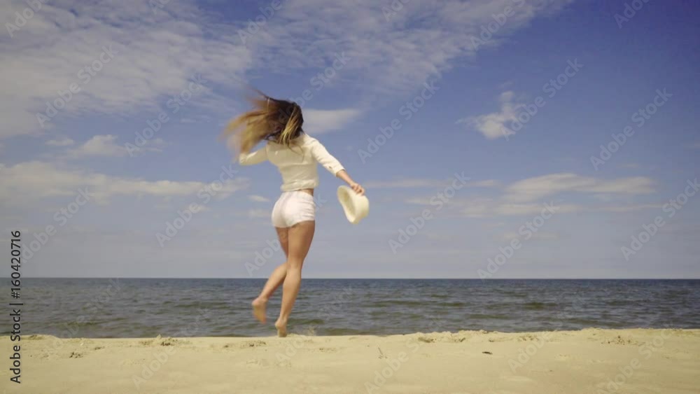 Happy girl having fun on beach. Young crazy woman playing on sea shore, dancing, jumping. Vacation happiness and craziness concept 4K ProRes HQ codec Happy girl having fun on beach. Young crazy woman playing on sea shore, dancing, jumping. Vacation happiness and craziness concept 4K ProRes HQ codec