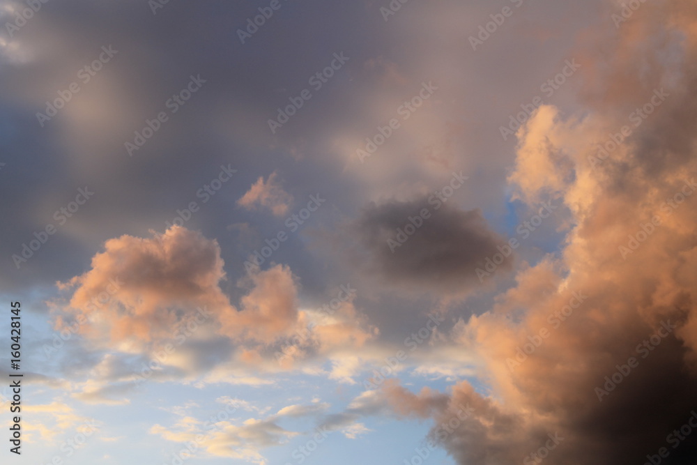Fototapeta premium Blue sky with dynamic colorful clouds after rain