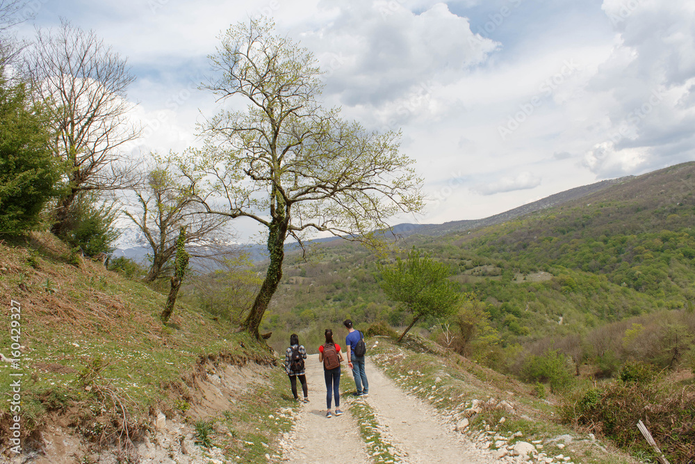 Travelers travel on the road in mountains go trekking Countryside, village - mountains, Clouds