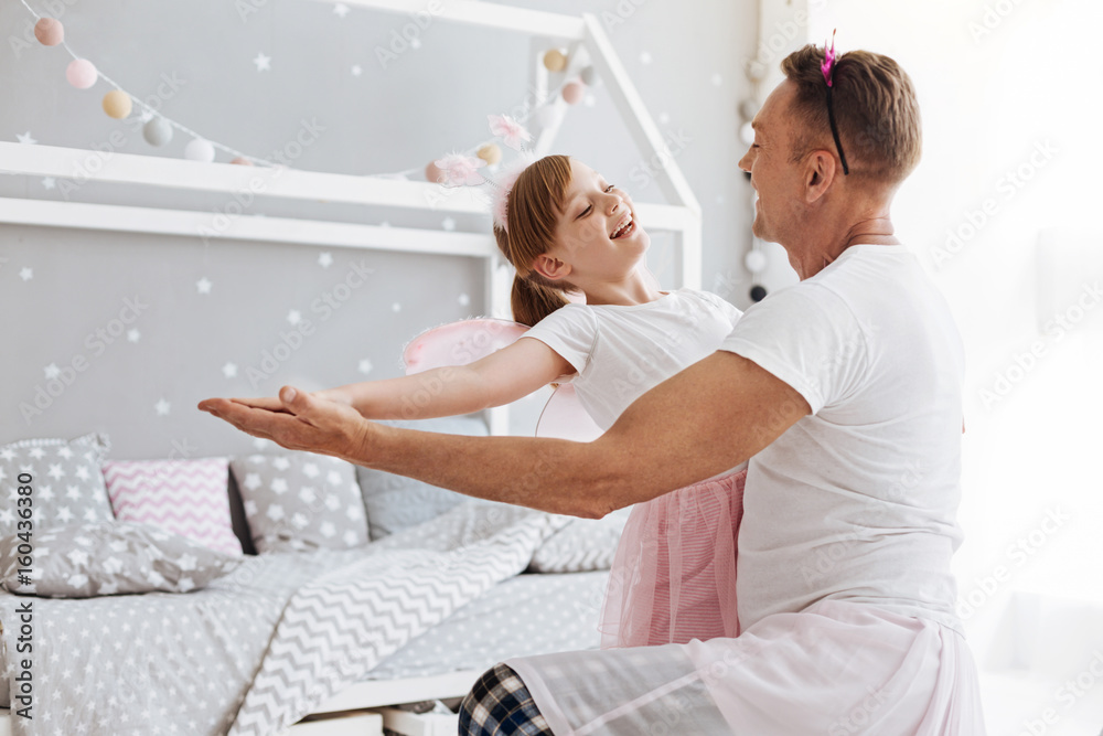 Fototapeta premium Talented dreamy girl loving dancing with dad