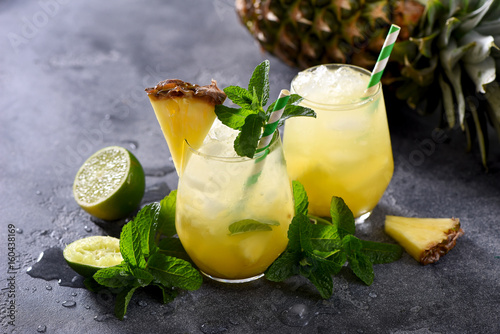 Cold pineapple drink with crushed ice, lime and mint