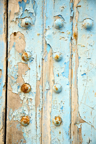 dirty stripped paint the blue wood door rusty nail