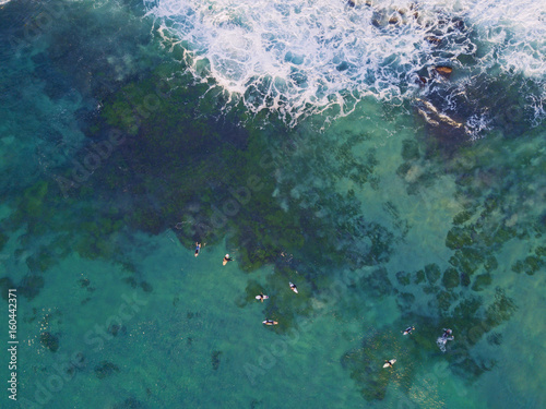 Aerial view group of surfers waiting for wave.