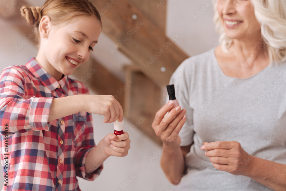 Happy pretty girl opening a nail varnish Happy pretty girl opening a nail varnish