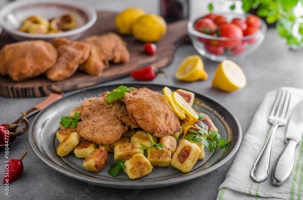 Schnitzel original with lemon and gnocchi fried Schnitzel original with lemon and gnocchi fried
