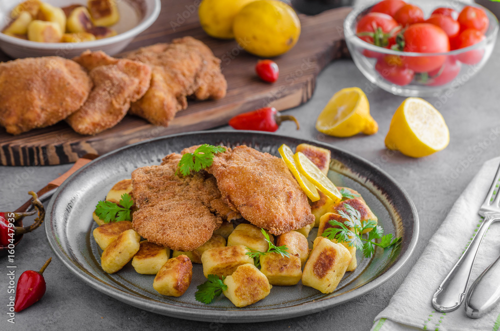 Schnitzel original with lemon and gnocchi fried Schnitzel original with lemon and gnocchi fried