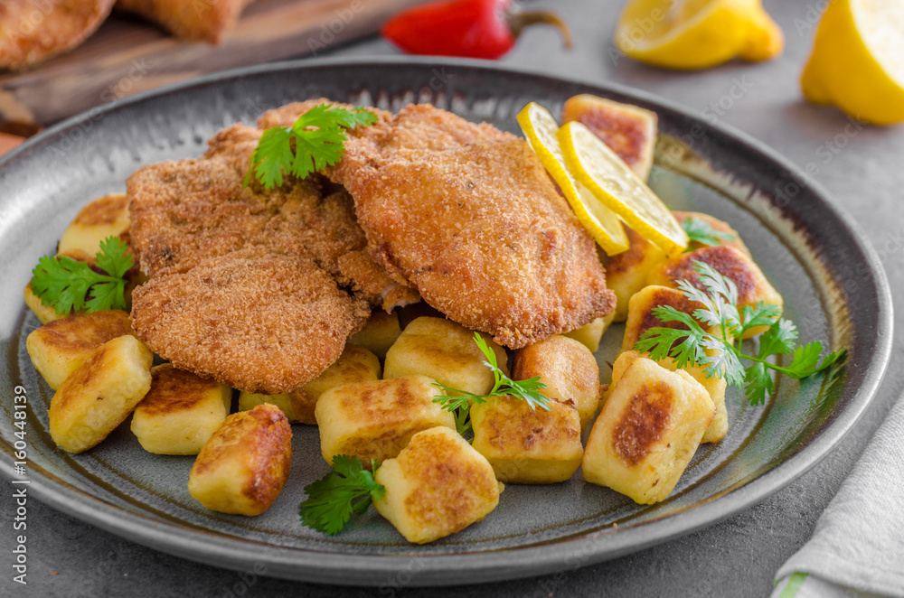 Schnitzel original with lemon and gnocchi fried Schnitzel original with lemon and gnocchi fried