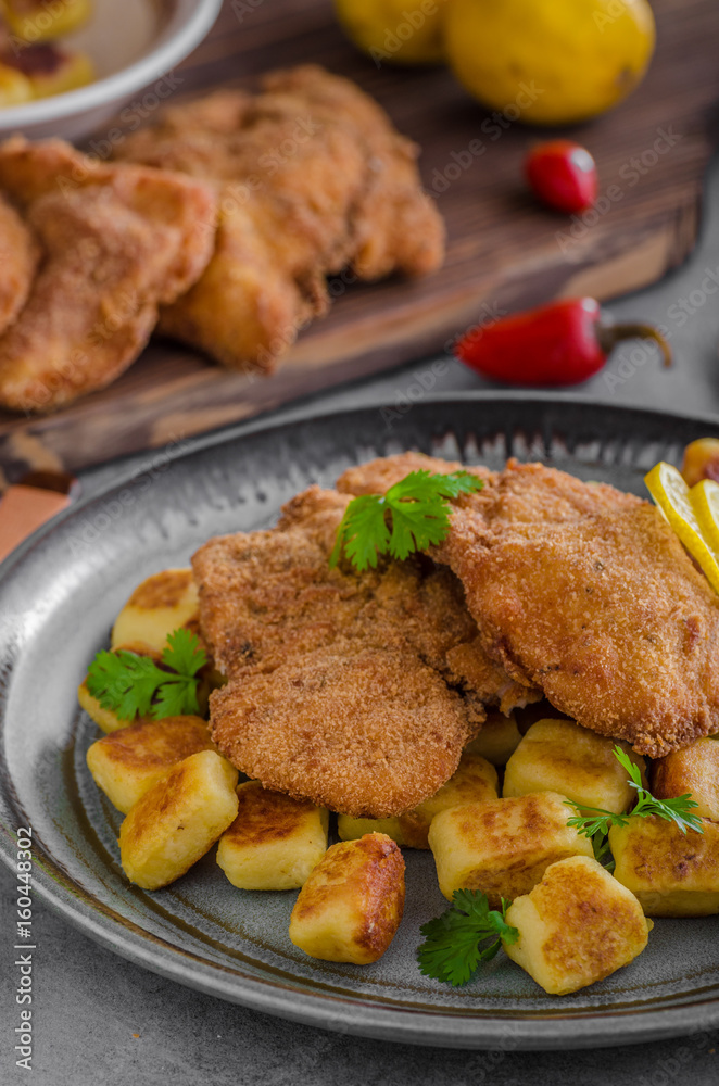 Schnitzel original with lemon and gnocchi fried Schnitzel original with lemon and gnocchi fried