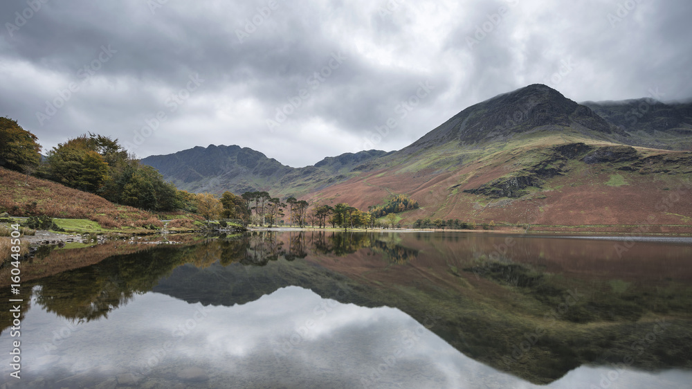 Stuning Autumn Fall landscape image of Lake Buttermere in Lake District England