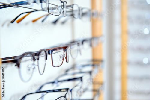 Fototapeta Naklejka Na Ścianę i Meble -  in optician shop- different  glasses for sale in wall rack