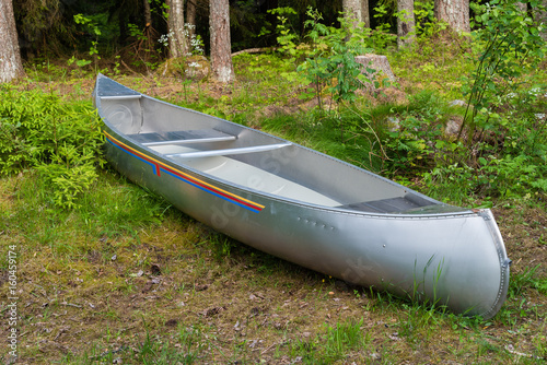 An aluminum canoe in a forest photo