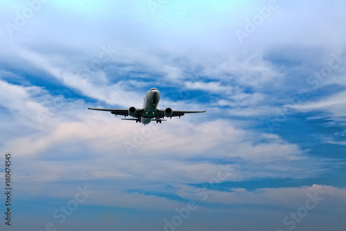 passenger plane flying in the blue sky