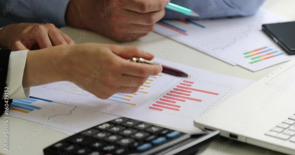 business colleagues discussing paperwork chart reports at office business colleagues discussing paperwork chart reports at office
