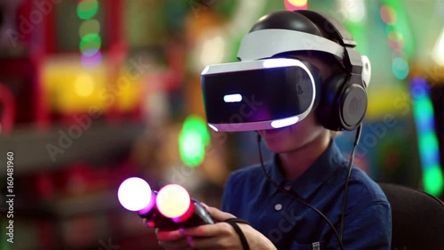 The boy plays in virtual reality on the console, modern entertainment technologies